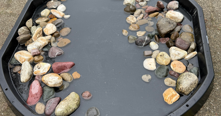 Outdoor learning — splashing through water in a tuff tray